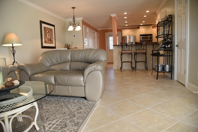 tiled living room featuring crown molding and a notable chandelier