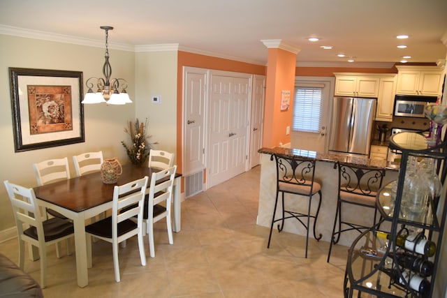 tiled dining space featuring ornamental molding