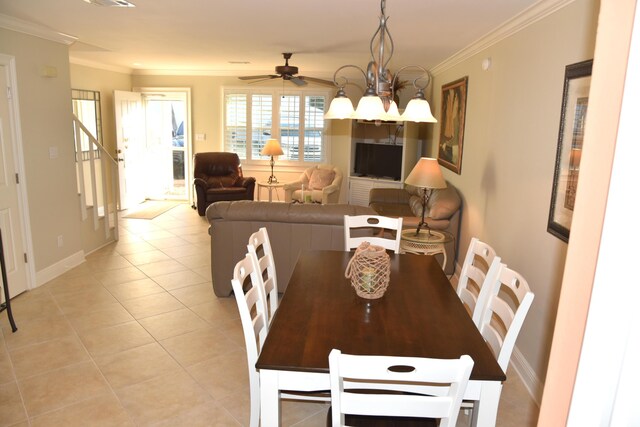 dining room featuring ceiling fan with notable chandelier, ornamental molding, and light tile patterned flooring