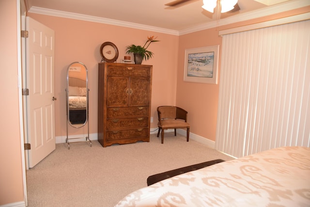 carpeted bedroom with ornamental molding and ceiling fan