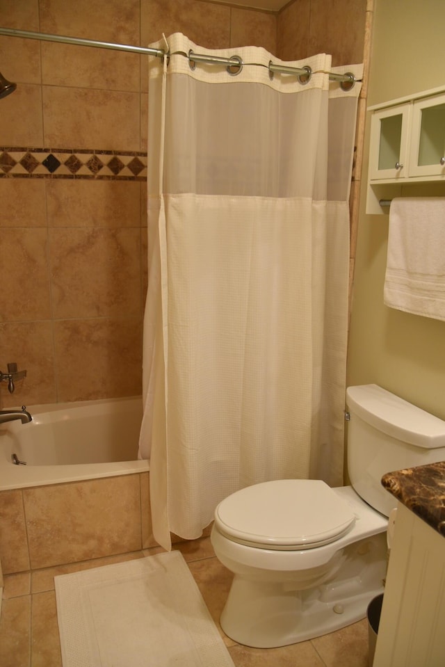 full bathroom featuring vanity, shower / bath combo, tile patterned floors, and toilet