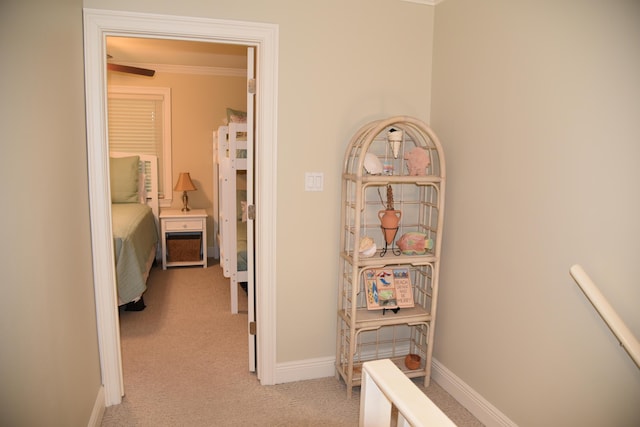 hall featuring light colored carpet and ornamental molding