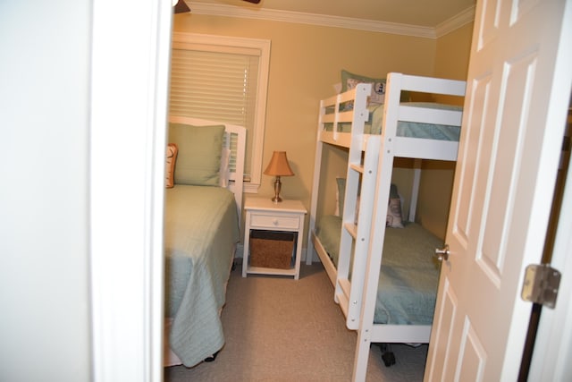 bedroom with ornamental molding and carpet flooring