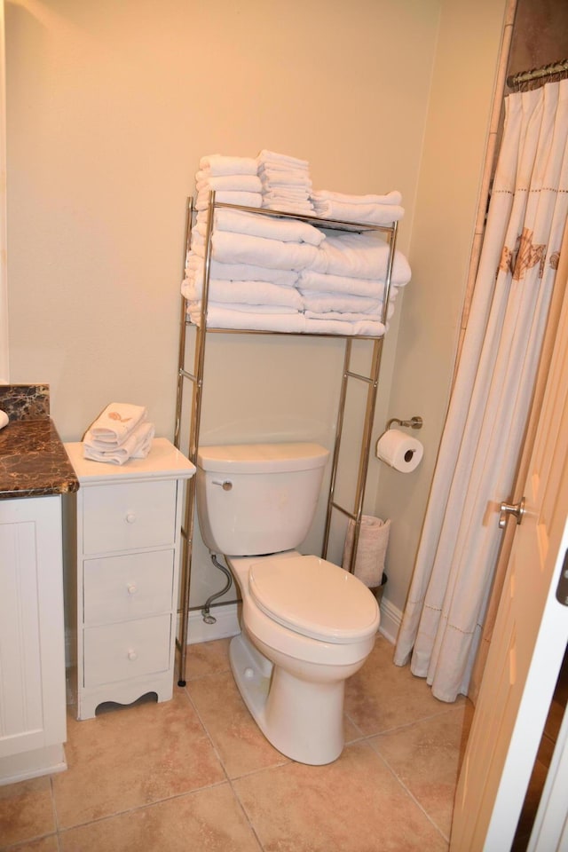 bathroom with vanity, tile patterned floors, and toilet