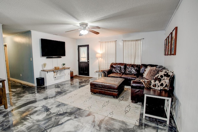 living room with ceiling fan, ornamental molding, and a textured ceiling