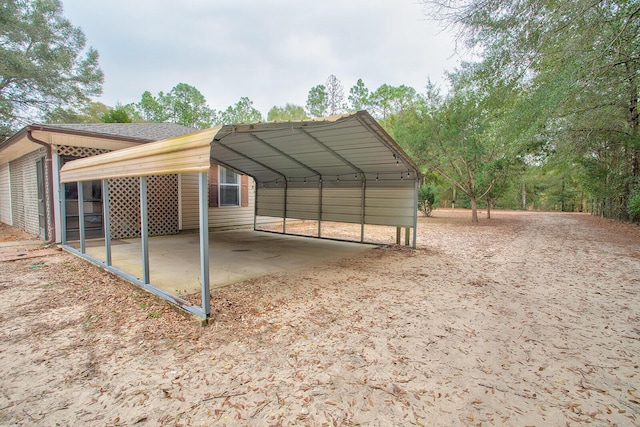 view of vehicle parking featuring a carport