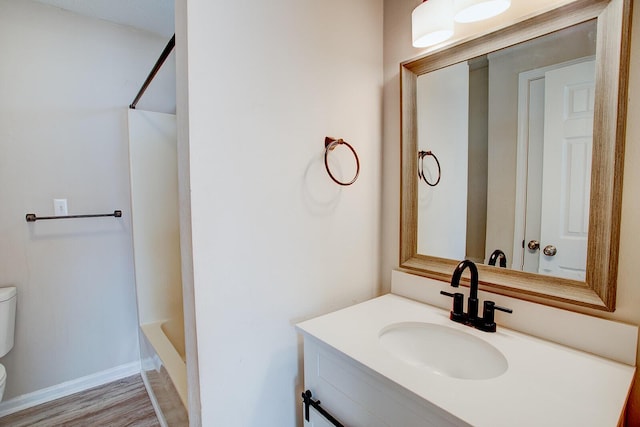 full bathroom with vanity, wood-type flooring, shower / washtub combination, and toilet