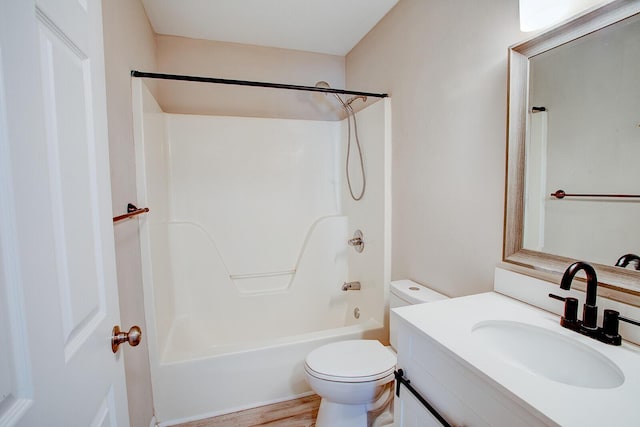 full bathroom featuring hardwood / wood-style flooring, vanity, washtub / shower combination, and toilet