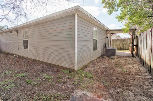 view of side of home with central AC