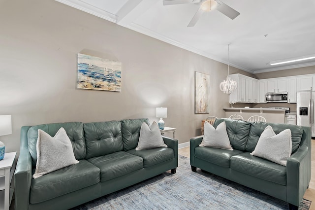 living area featuring ceiling fan with notable chandelier, ornamental molding, and baseboards