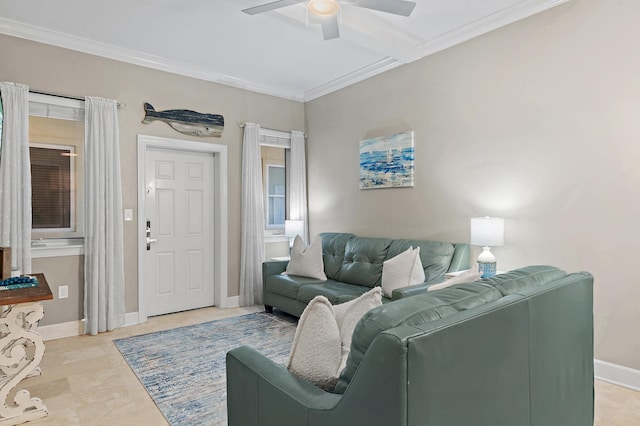 living area featuring ornamental molding, a ceiling fan, and baseboards