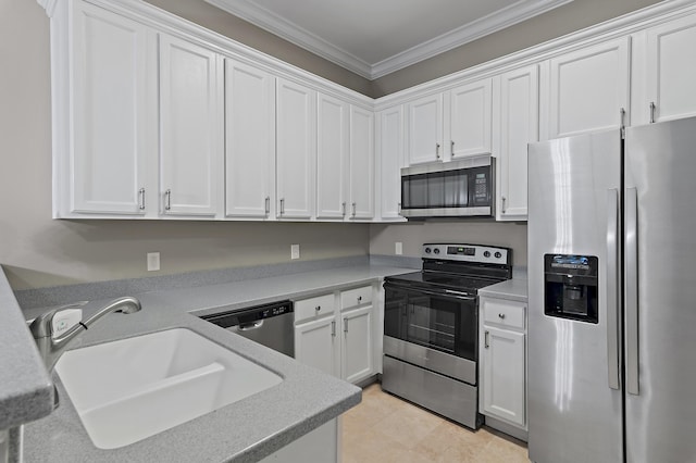 kitchen with stainless steel appliances, a sink, white cabinets, light countertops, and crown molding