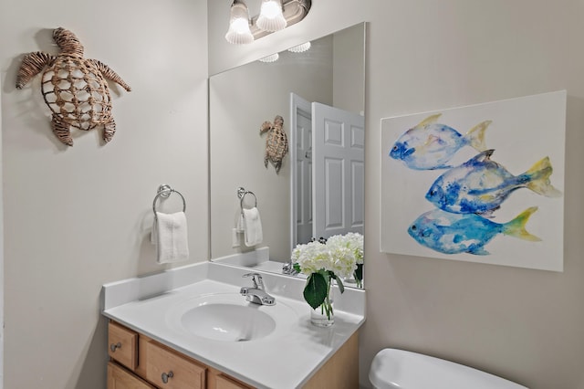 bathroom featuring toilet and vanity