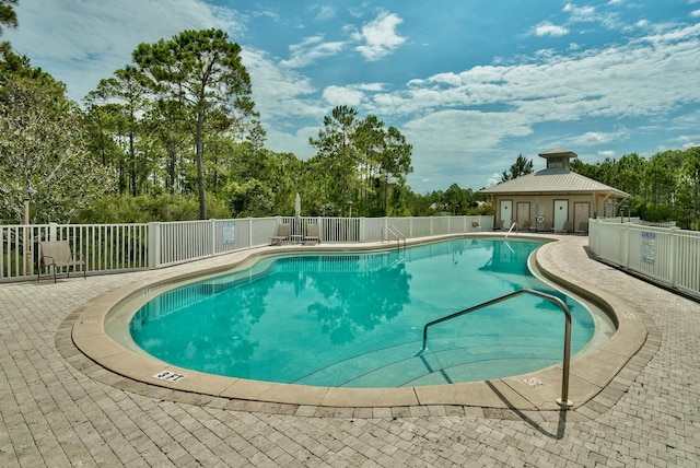 pool featuring a patio area and fence