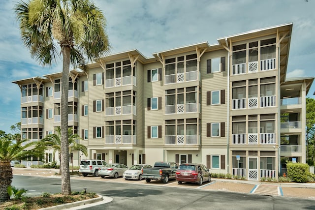 view of building exterior with uncovered parking