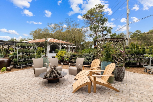 view of patio / terrace featuring an outdoor fire pit