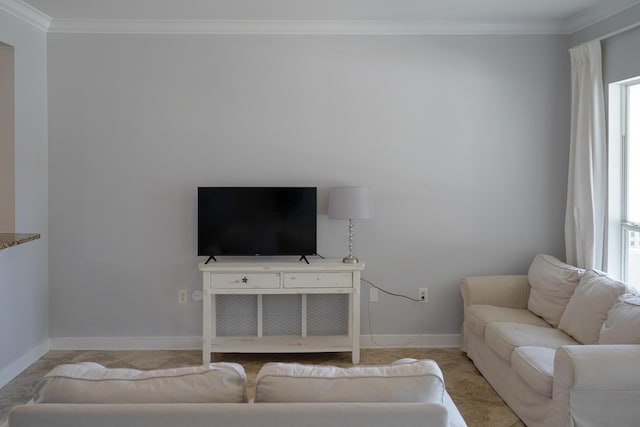 living area featuring baseboards and ornamental molding