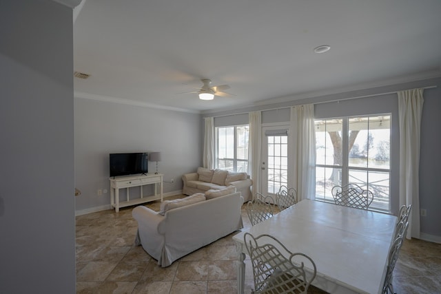 living room with plenty of natural light, visible vents, crown molding, and a ceiling fan