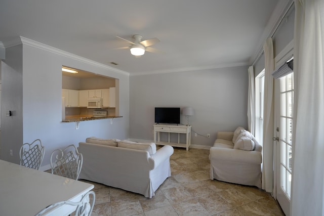 living room with crown molding, a ceiling fan, visible vents, and baseboards