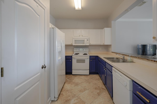 kitchen with white appliances, blue cabinetry, light countertops, and a sink