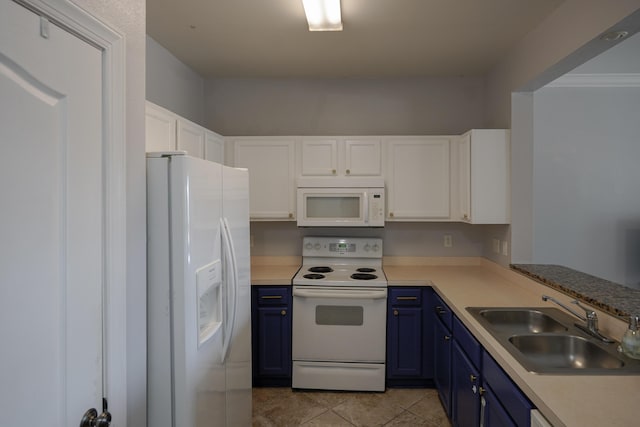 kitchen with blue cabinetry, white appliances, white cabinetry, and a sink