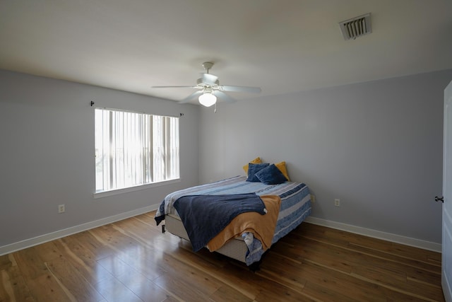 bedroom with visible vents, baseboards, and wood-type flooring