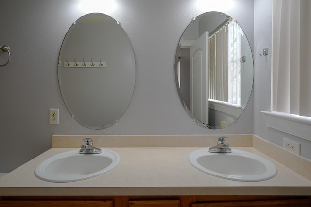 bathroom featuring double vanity and a sink