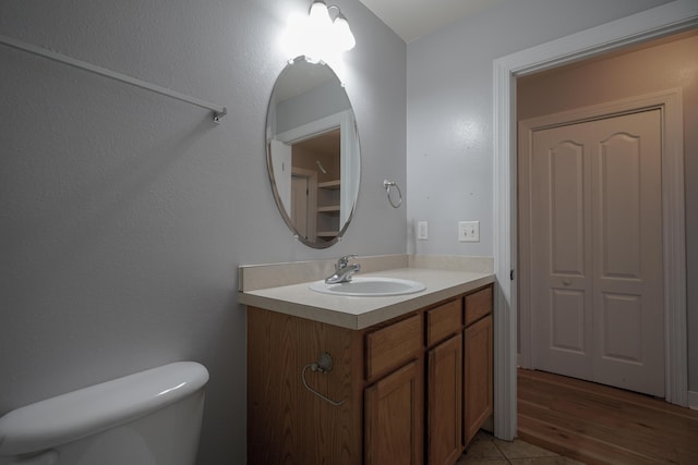 half bath featuring toilet and vanity