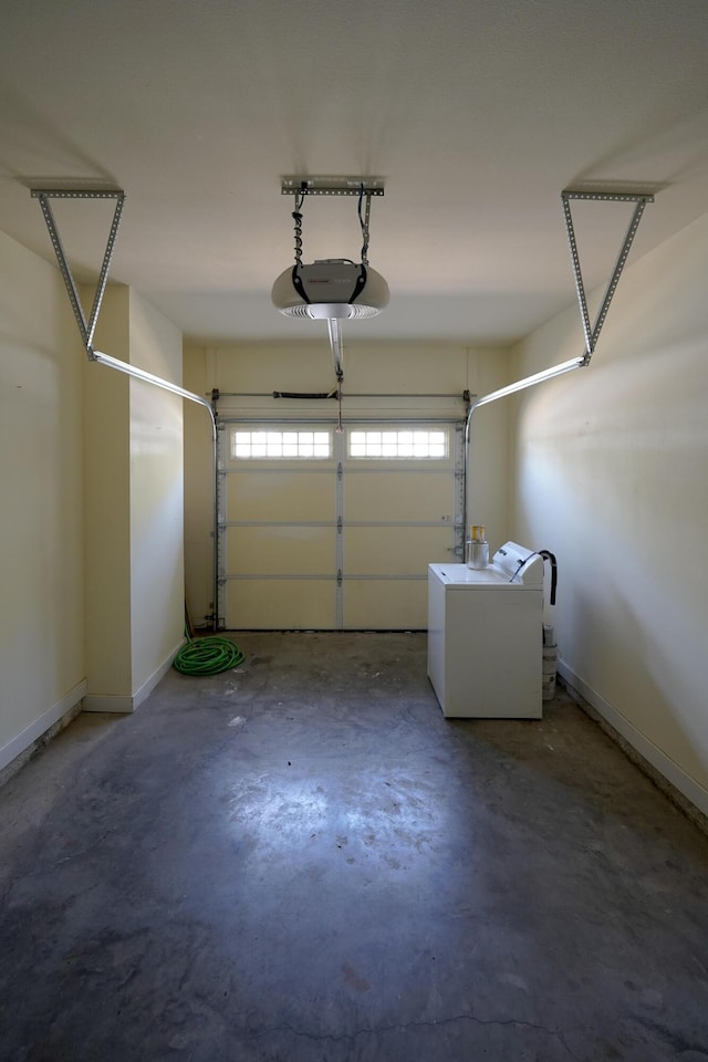 garage with washer / dryer, a garage door opener, and baseboards