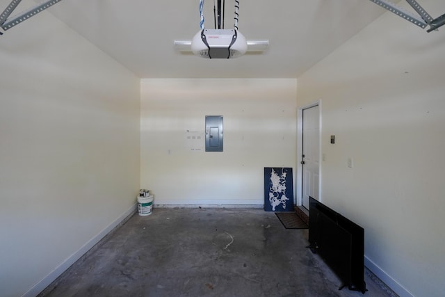 garage featuring electric panel, a garage door opener, and baseboards