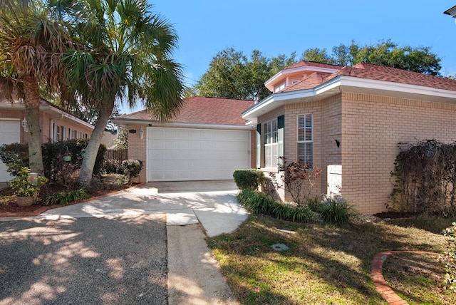 view of front facade featuring a garage, concrete driveway, and brick siding