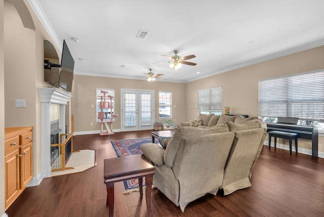 living room with dark wood-style floors, plenty of natural light, and a premium fireplace