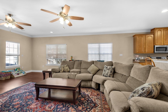 living room with baseboards, dark wood finished floors, a ceiling fan, ornamental molding, and recessed lighting