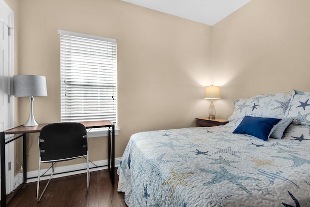 bedroom with dark wood-style flooring and baseboards