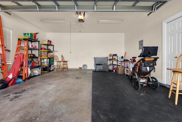 garage featuring a garage door opener and electric panel