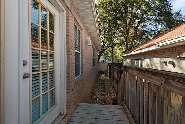 view of home's exterior with fence and brick siding