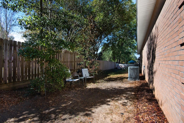 view of yard with cooling unit and a fenced backyard