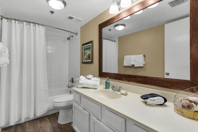 full bathroom featuring vanity, hardwood / wood-style flooring, toilet, and shower / bath combo with shower curtain