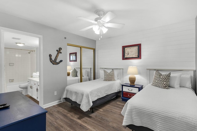 bedroom featuring dark wood-type flooring, ceiling fan, connected bathroom, and a closet