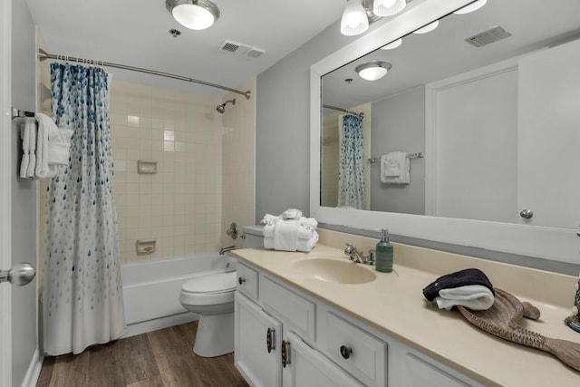 full bathroom featuring wood-type flooring, toilet, shower / tub combo with curtain, and vanity