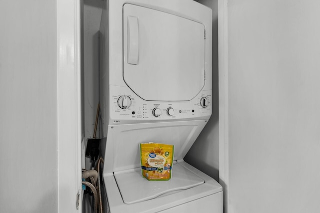 laundry area featuring stacked washer / drying machine