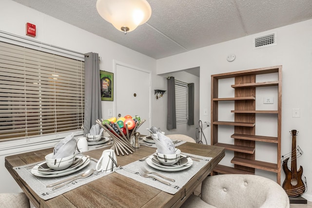 dining space with a textured ceiling