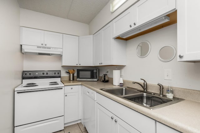 kitchen with white appliances, light tile patterned floors, sink, and white cabinets