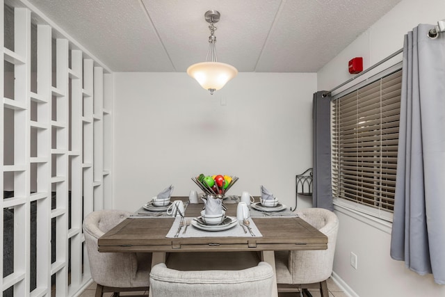 dining space featuring a textured ceiling