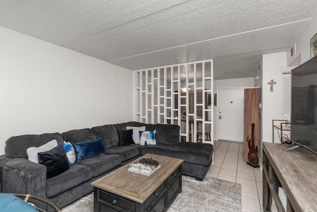 living room featuring a textured ceiling and tile patterned floors