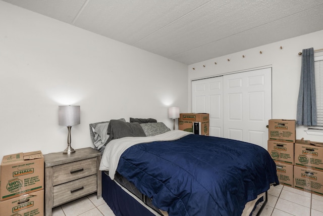 tiled bedroom with a closet