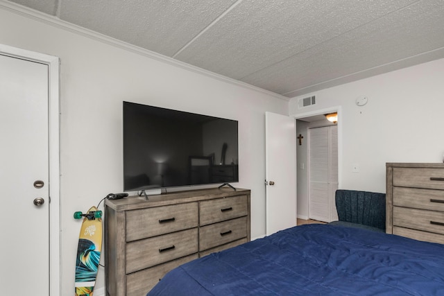 bedroom with crown molding and a textured ceiling