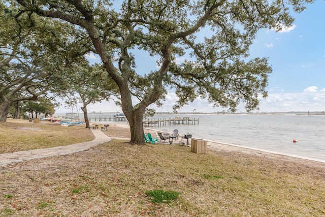 dock area featuring a yard and a water view