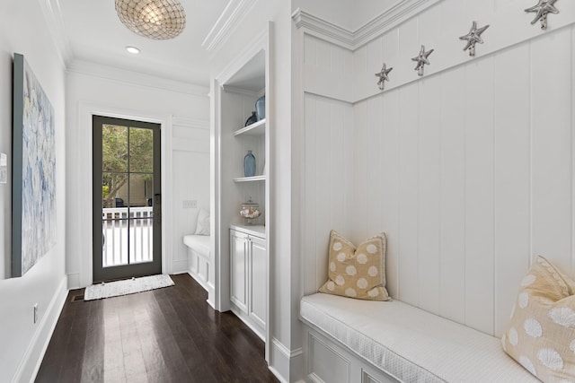 mudroom with crown molding, dark hardwood / wood-style flooring, and built in shelves