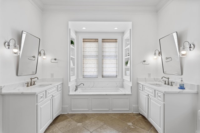 bathroom with crown molding, vanity, and a bathtub